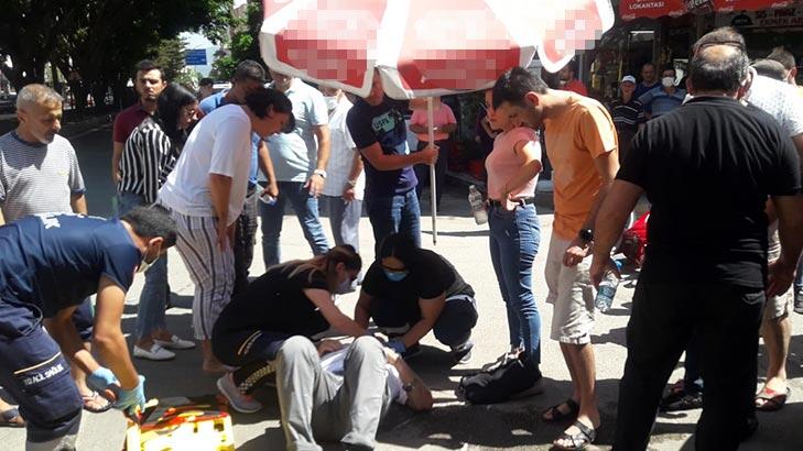 İnsanlık ölmemiş dedirten kare! Yaralının başında plaj şemsiyesiyle beklediler